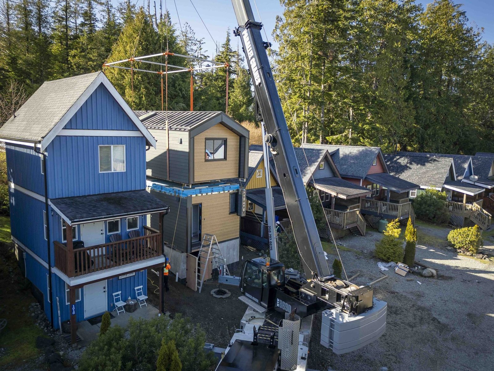 Crane setting a module on site