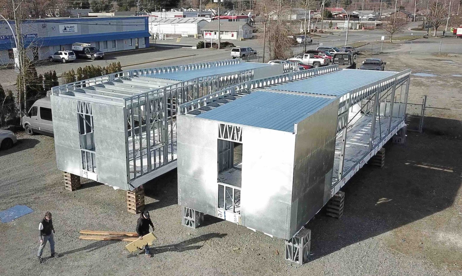 Two light-gauge steel modules on cribbing in a yard